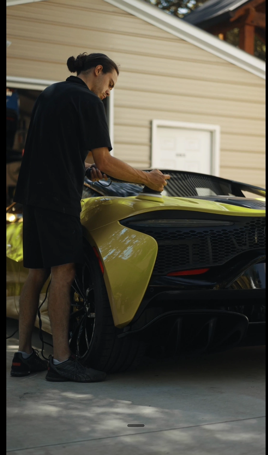 Michael polishing a yellow exotic supercar in a driveway