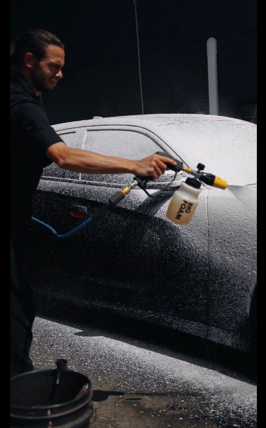 Michael applying foam pre-soak to a customer's car