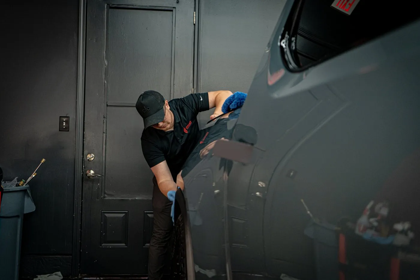 Upstate Auto Styling tech leveling ceramic coating on a dark SUV