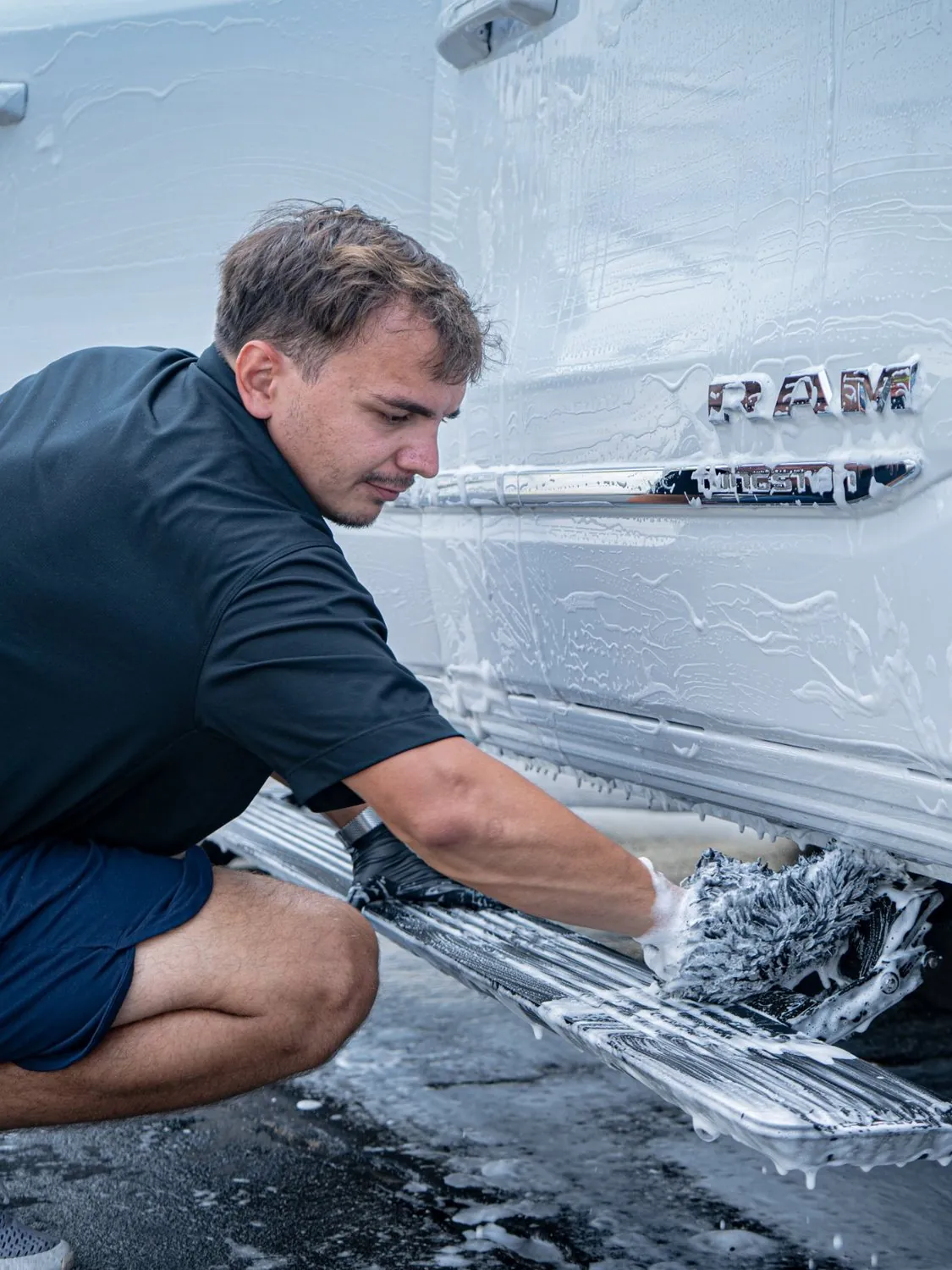 Detailer foam washing a white Ram before coating